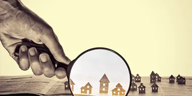 Inspecting house with magnifying glass - Best Home Buying Realtors In Seattle